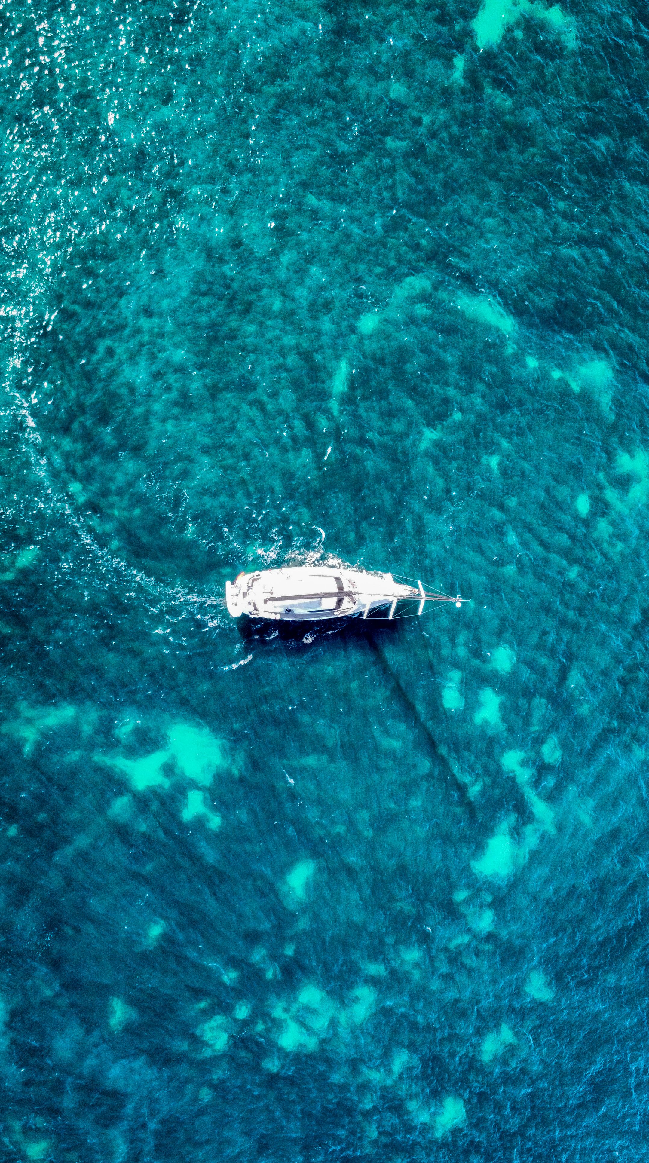 White yacht floating over clear turquoise water
